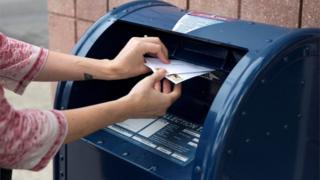 A woman posts a letter