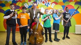 Benny Higgins with some of the children who are learning to play an instrument