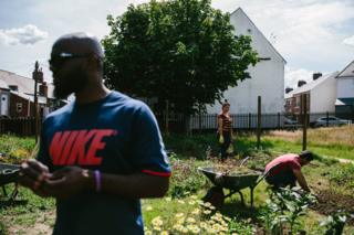 Three participants work on the allotment