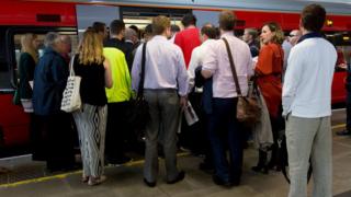 People queuing to get on a train