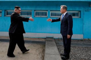 North Korean leader Kim Jong-un (left) shakes hands with South Korean President Moon Jae-in