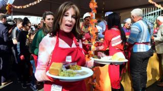 Actress Kate Kinder helps serve at the annual LA Mission Thanksgiving meal for the homeless on Skid Row in Los Angeles, California on November 21, 2018