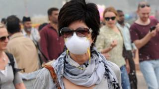 A foreigner wearing an anti-pollution mask walks a street in New Delhi, India, 5 November 2016.
