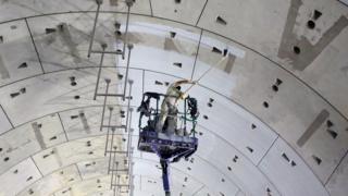 A laborer paints the walls of one of the new tunnels under the Suez Canal, in Ismailia, 120km east of Cairo, Egypt, 04 September 2018