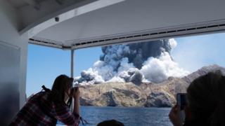 A volcano erupting on White Island.