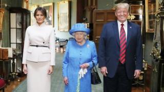 Queen Elizabeth II stands with US President Donald Trump and his wife, Melania, in the Grand Corridor during their visit to Windsor Castle