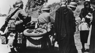 German troops questioning Belgian refugees, 31 May 1940