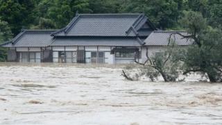 The Kuma river bursts its banks in Yatsushiro in Kumamoto prefecture