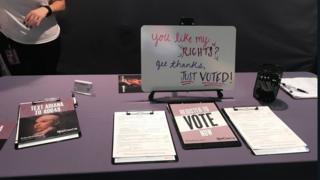 Table shows voter registration forms at Ariana concert