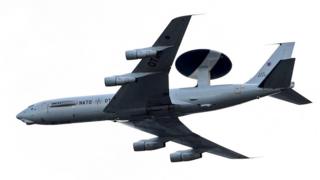 An AWACS aircraft flies over the PGE National Stadium, the venue of the NATO Summit, in Warsaw, Poland on 8 July