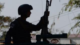 An Afghan policeman keeps watch at the site of a suicide bomb attack near a Shia mosque in Kabul, 29 September 2017