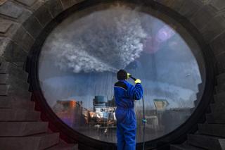 A worker disinfects a window