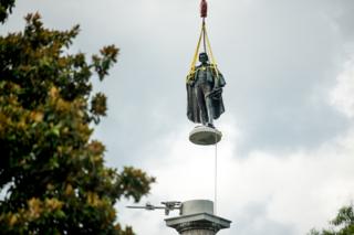 in_pictures A statue of John C Calhoun is lifted from its pedestal
