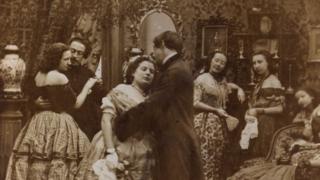 Victorian couples kissing underneath the mistletoe