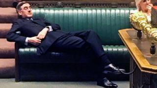 Jacob Rees-Mogg lying on chairs in Parliament