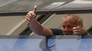 Former President Lula gestures from prison window