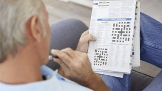 Man doing crossword puzzles