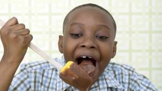 A boy eating chocolate.
