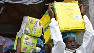 Health Ministry employees load a truck after emptying shops selling fake medicine during a raid monitored by police against shops selling counterfeit drugs on May 3, 2017 at the Adjame market in Abidjan.