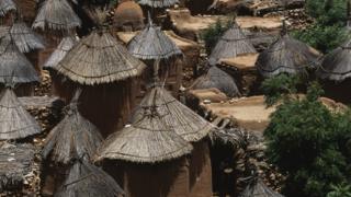 We see thatched huts in this photo of a traditional Dogon village