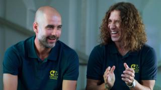 Former Barcelona player Carles Puyol (right) at an event in Madrid in May 2018 talking to Manchester City coach Pep Guardiola (left)