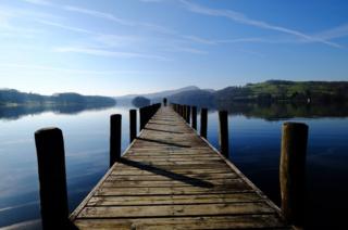 A man standing at the end of a jetty