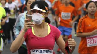 Chinese runner using a smartphone