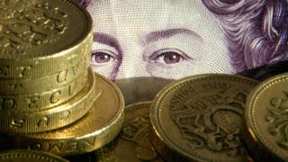 pile of pound coins and notes