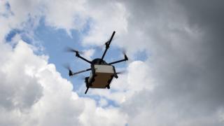 The image taken on September 28, 2015 shows a Geopost Drawn flying in PuertoReres, Southeastern France, during a presentation of a prototype of a package delivery drone