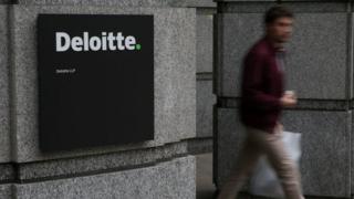 Man walks out of Deloitte office