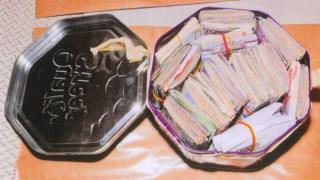 Tin filled with cash
