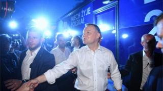 Andrzej Duda greets supporters after learning the initial projections following the first round of the presidential election in Lowicz, central Poland, 28 June 2020