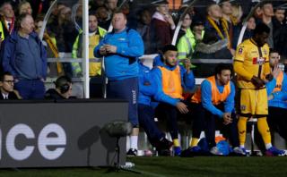 20/2/17: Sutton United's substitute Wayne Shaw eats a pie during the FA Cup match against Arsenal