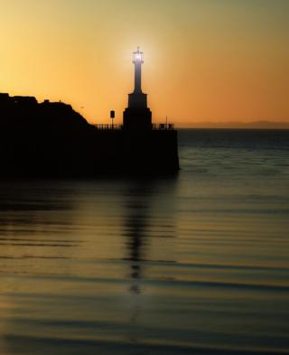 Sunset behind a lighthouse