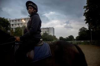 A young boy rides a horse