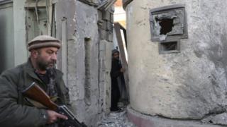 A member of the Afghan security forces guards at the scene of the attack in Kabul. Photo: 12 December 2015