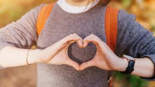 Close-up of hands forming a heart shape