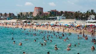 Swimmers on a beach in Spain