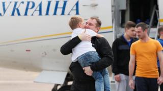 Freed Ukrainian prisoner embraces his relative upon arrival in Kiev after Russia-Ukraine prisoner swap, at Borispil International Airport, outside Kiev.