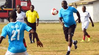 George Wia plays a football game in Liberia