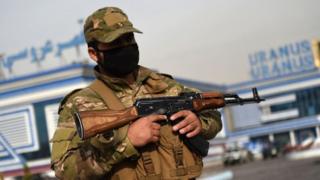 A member of the Afghan security forces stands guard after a Taliban attack in Kabul in November 2018