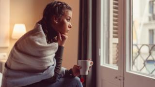 Woman looking out of window