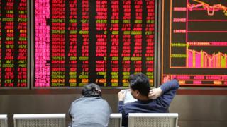 Investors observe stock market at an exchange hall on January 6, 2016 in Beijing, China.