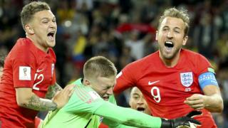 England captain Harry Kane celebrates victory over Colombia with Jordan Pickford and Kieran Trippier