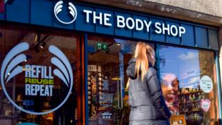 A woman walks past a Body Shop store in Central London on 12 February 2024