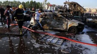 Civilians and security forces gather at the scene of a deadly car bomb in the Habibiya area of Sadr City, Baghdad 15/08/2015