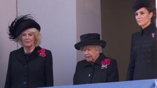 The Queen watching from a balcony