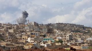 Smoke billows on the horizon near the Syrian Kurdish city of Afrin on March 15, 2018