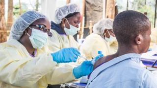 A healthcare member inoculates a man for Ebola in Butembo, Democratic Republic of the Congo on July 27, 2019.