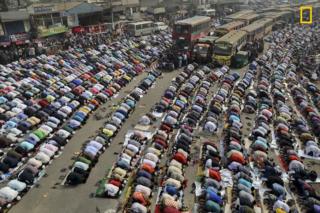 People praying on the street in Dhaka